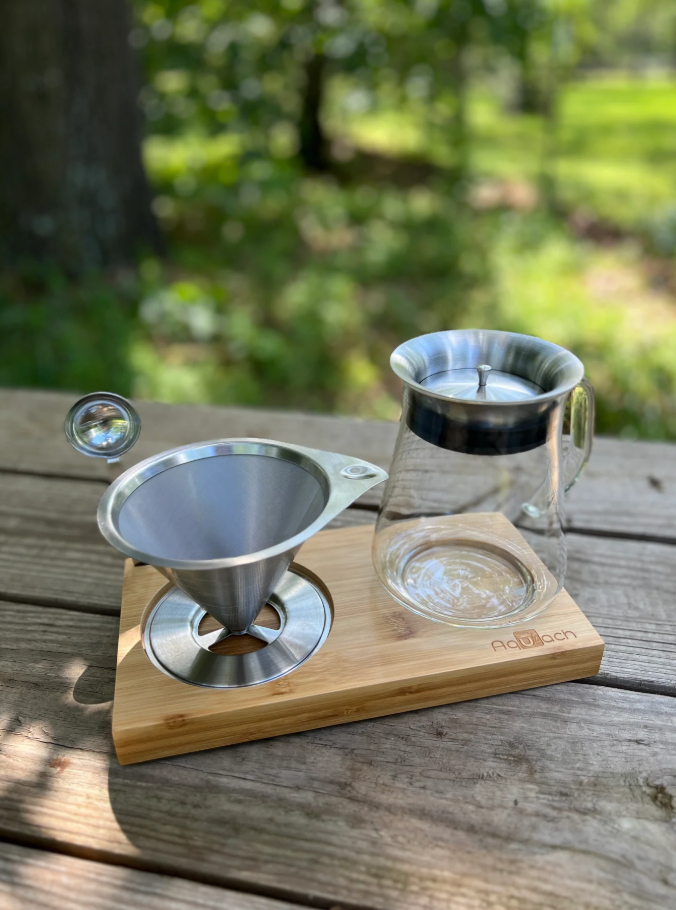 Aquatech pour over on a picnic table with grass in the background | Headcount Coffee
