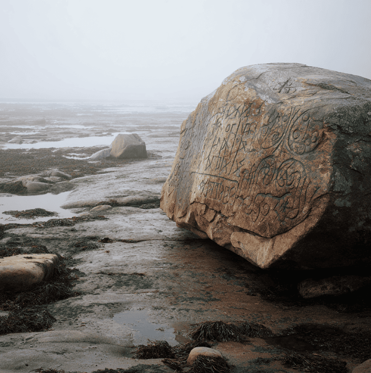 Stone with shallow rune-like markings associated with the Yarmouth Runic Stone mystery on the Nova Scotia coast.