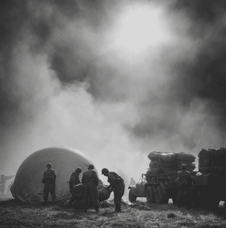 WWII soldiers deploying an inflatable tank used by the Ghost Army for battlefield deception.