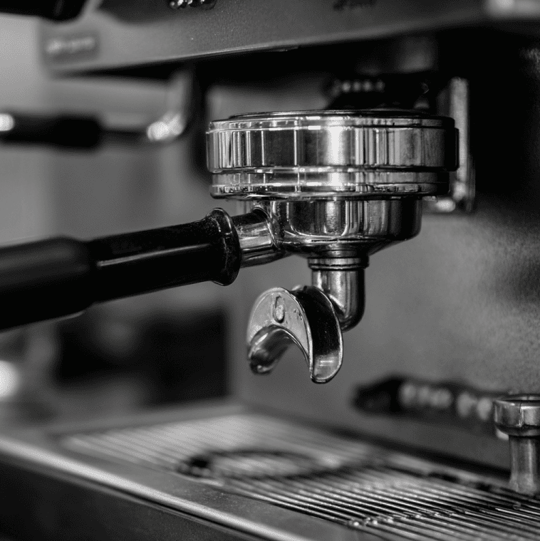 Espresso machine group head with heated metal components, illustrating the debate over thermal memory and flavor retention.