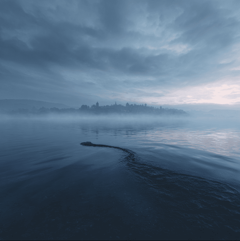 Misty Lake Brosno with a faint serpentine shape below the surface, referencing the Brosno Dragon legend.