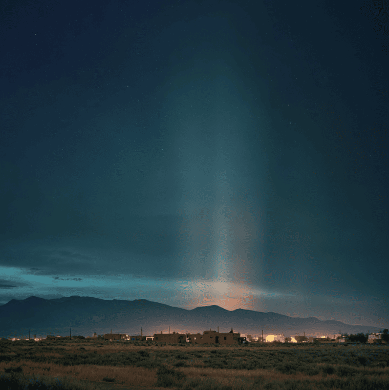 Taos, New Mexico at night with a symbolic depiction of low-frequency vibrations representing the unexplained Taos Hum.