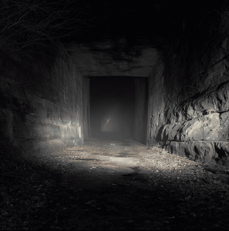 Dark limestone passage of the Screaming Tunnel near Niagara Falls, associated with reported screams and haunting legends.