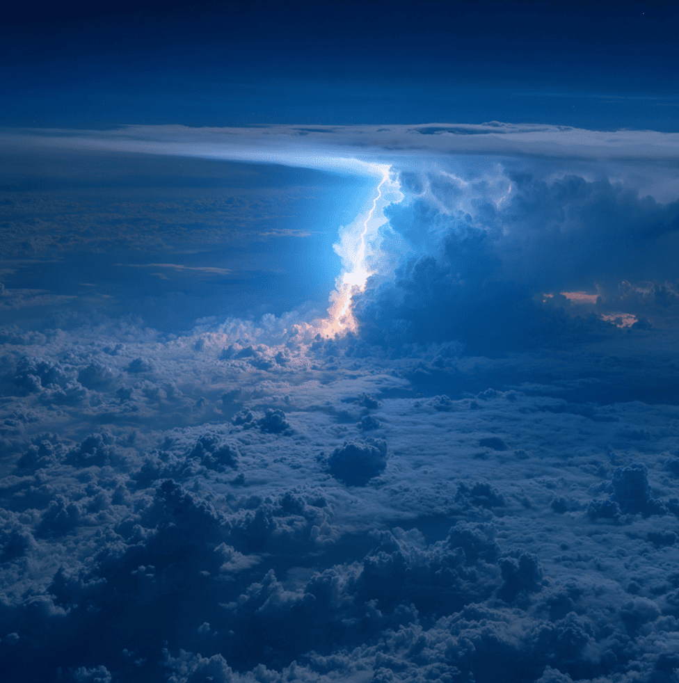 Blue jet lightning shooting upward from a thunderstorm into the upper atmosphere.