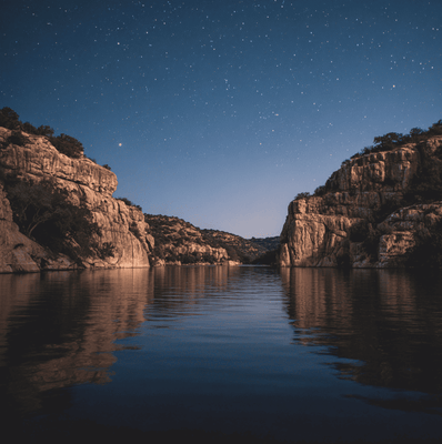 Moonlit view of Lake Meredith with still water and canyon walls, suggesting mysterious music reported by campers beneath the surface.