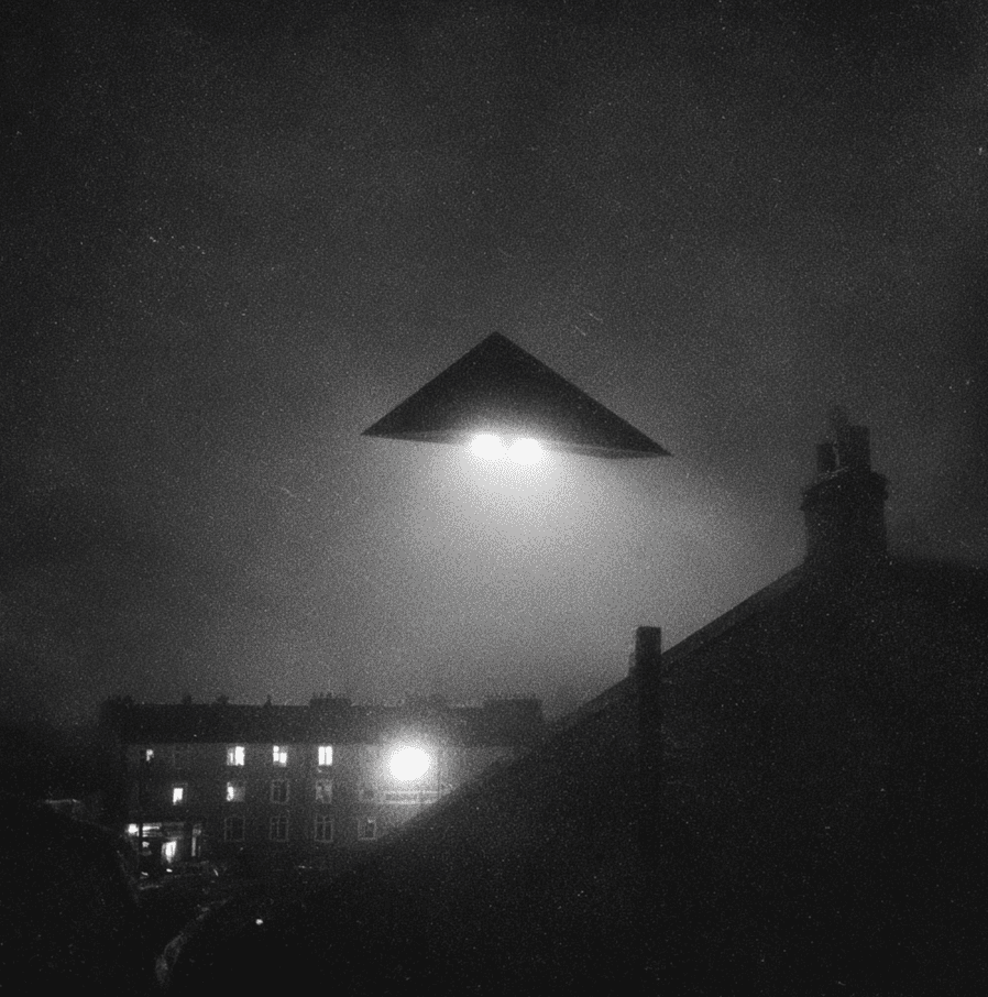 Black triangular UFO with three bright lights hovering over Belgium, representing the 1989–1990 Belgian Wave sightings.