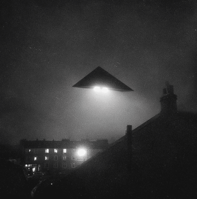 Black triangular UFO with three bright lights hovering over Belgium, representing the 1989–1990 Belgian Wave sightings.