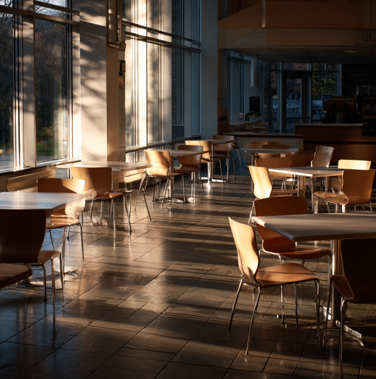 Virginia Tech student cafeteria interior at dusk, quiet and somber atmosphere symbolizing tragedy and remembrance