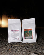 Headcount Coffee Bigfoot’s Brew dark roast organic coffee bags from Texas coffee roastery shown outdoors at night.