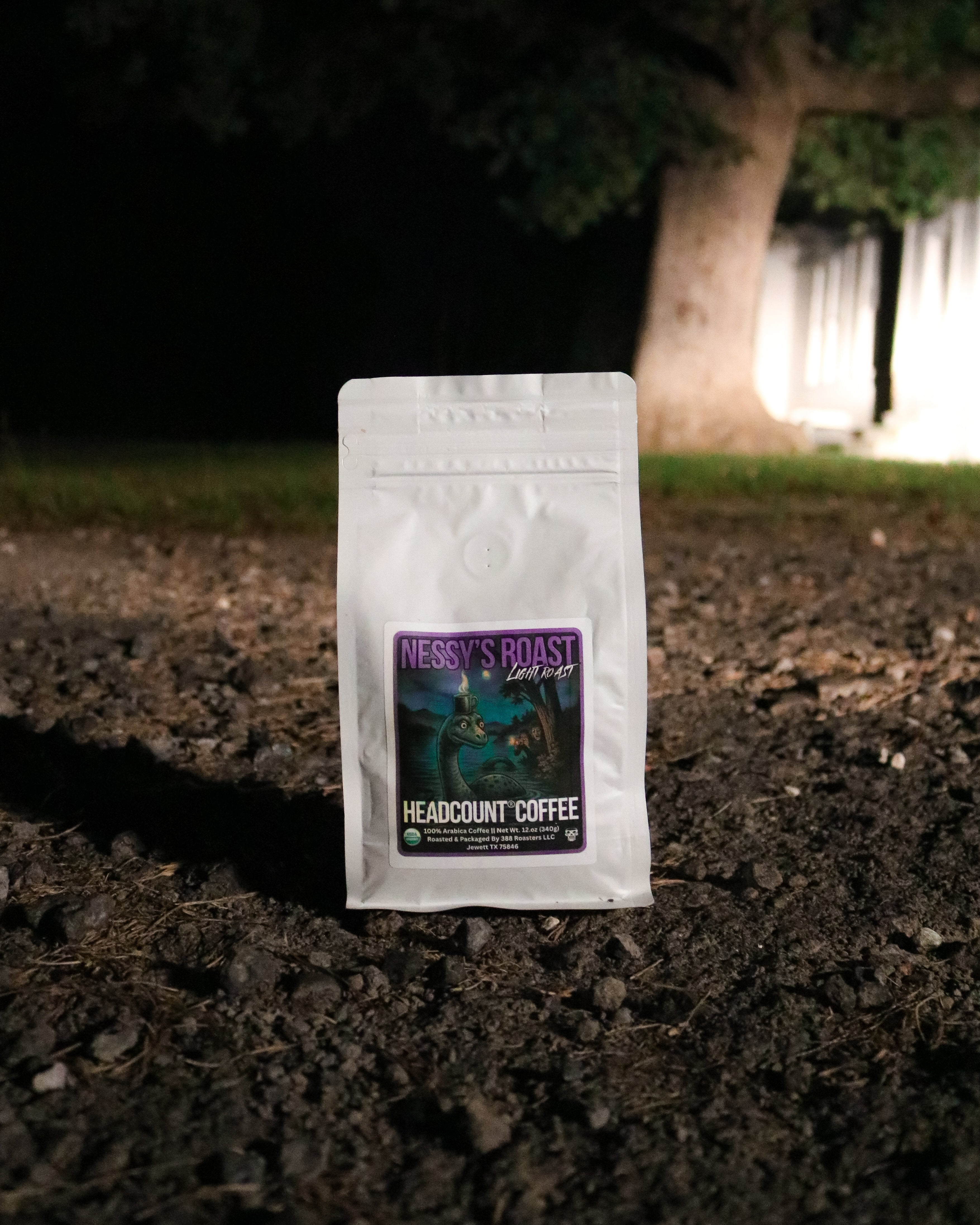 Neogy's Roast Headcount Coffee package on dark soil with a blurred background